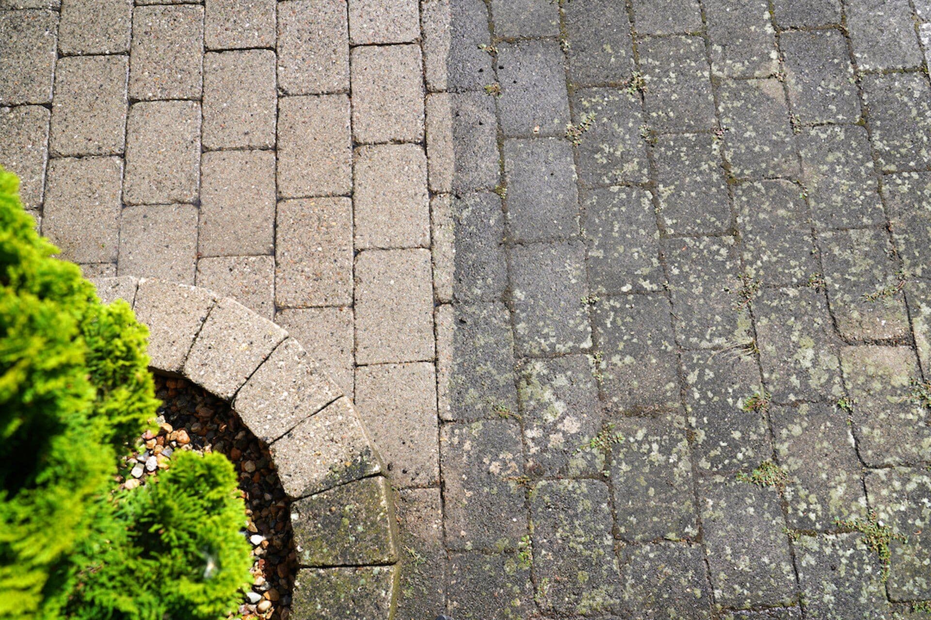 Paved area before and after stone cleaning.